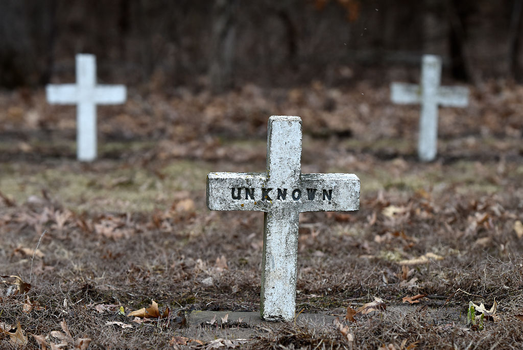 A few white crosses in the slave cemetery are engraved